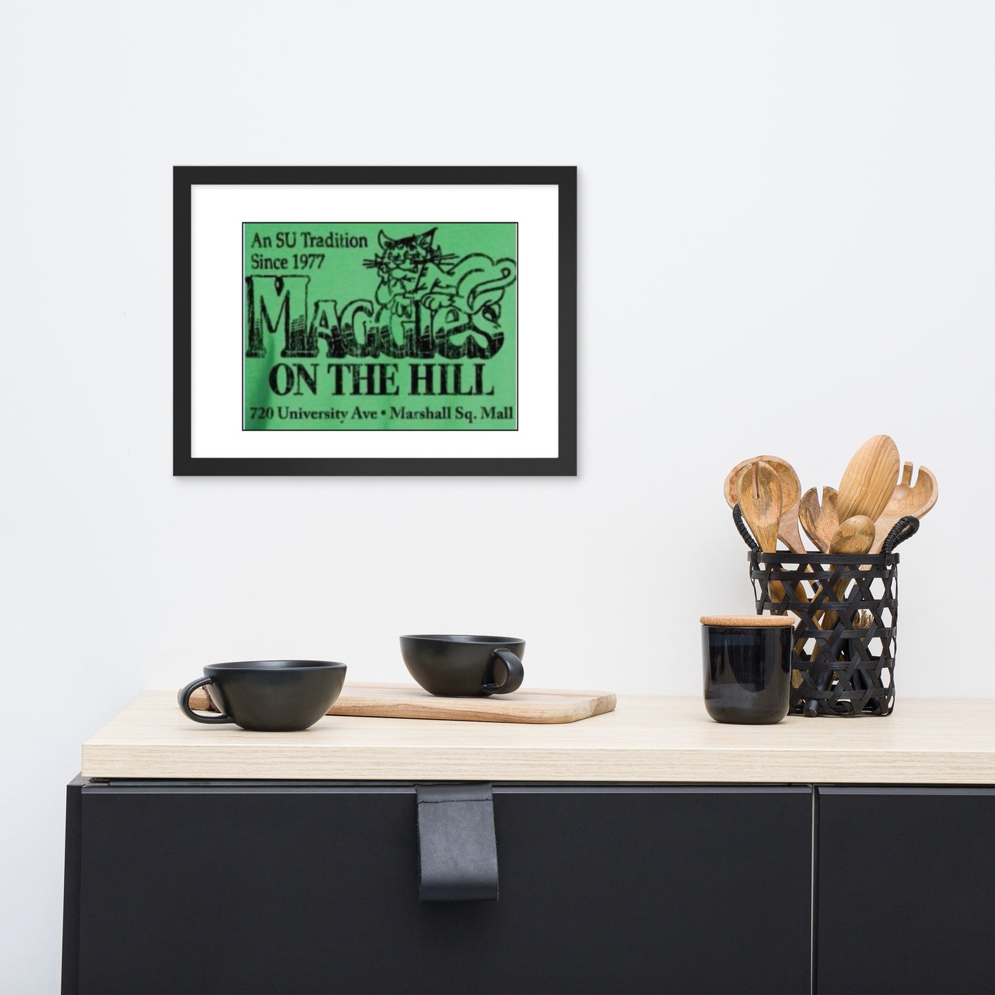 Black framed green college bar logo that says 'Maggie's on the Hill'