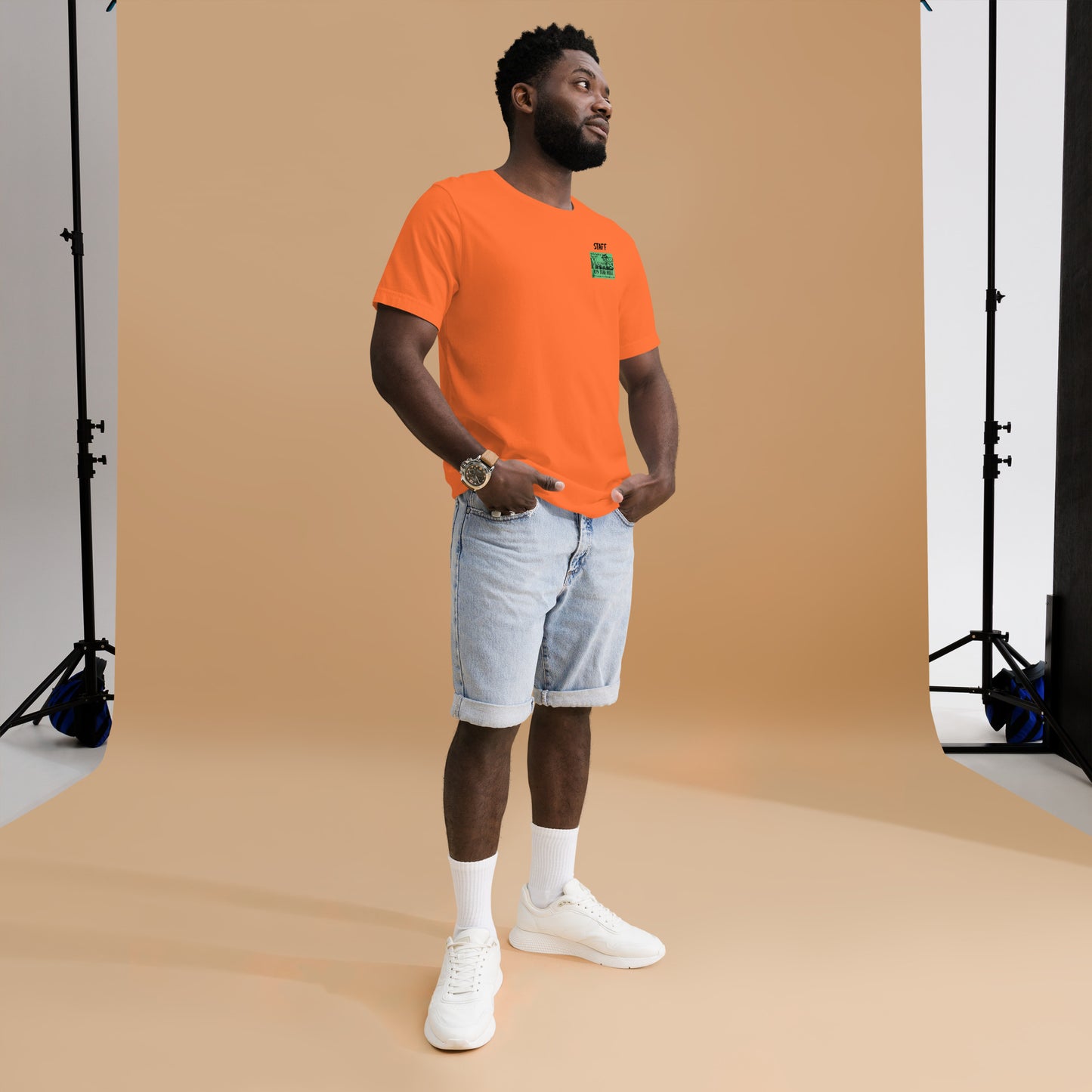 Orange unisex T shirt that says 'Maggie's on the Hill - Staff'