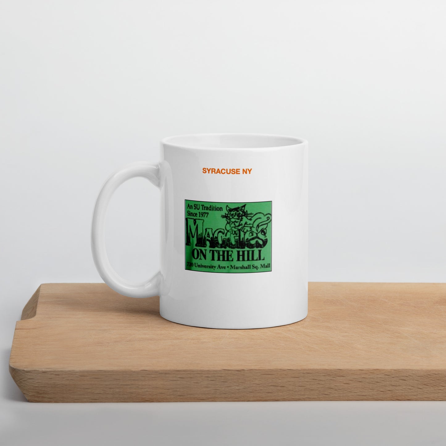 White mug says 'Syracuse NY, Maggie's'