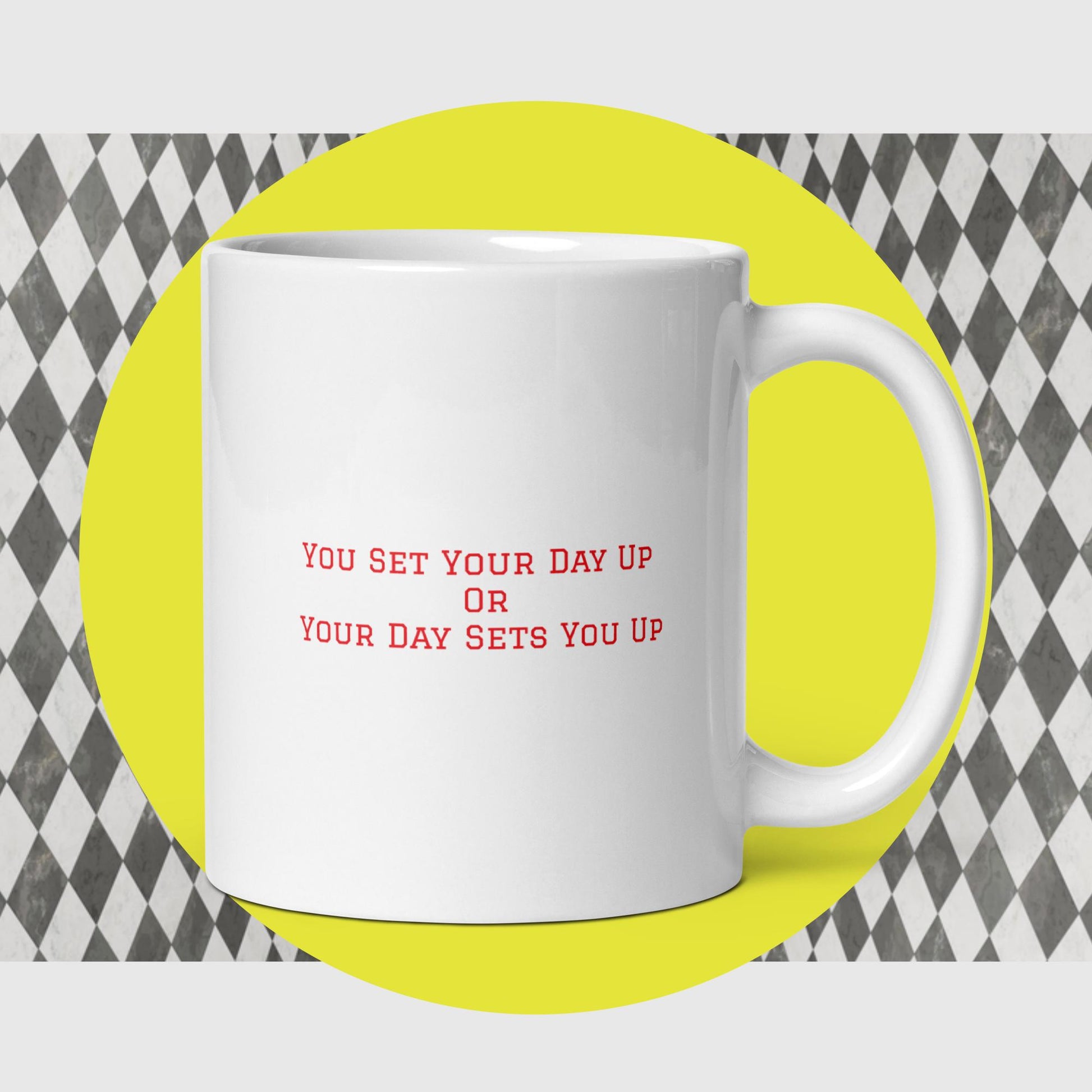 White mug says "You Set Your Day Up Or Your Day Sets You Up" in red