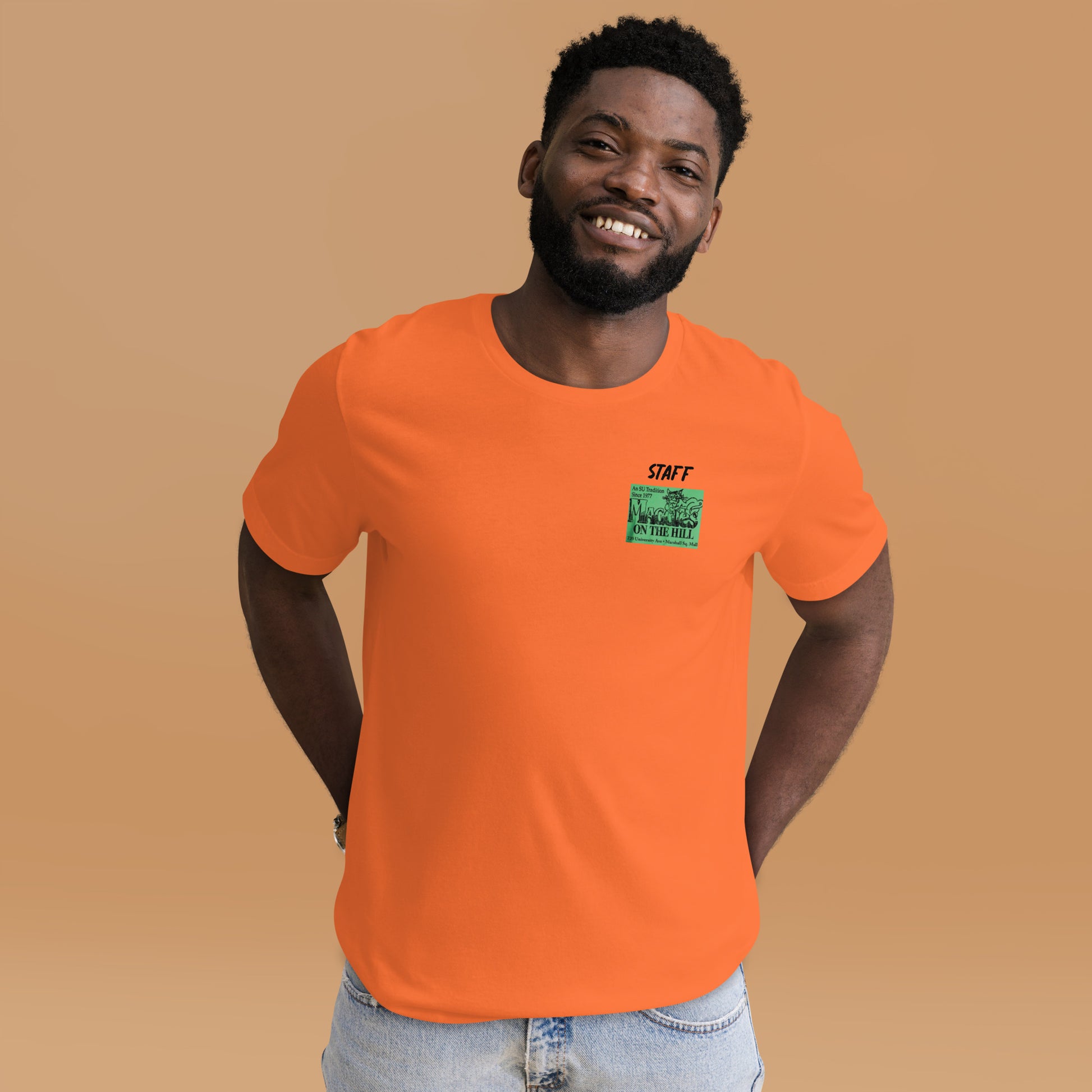 Orange unisex tee that says 'Maggie's on the Hill - Staff' 
